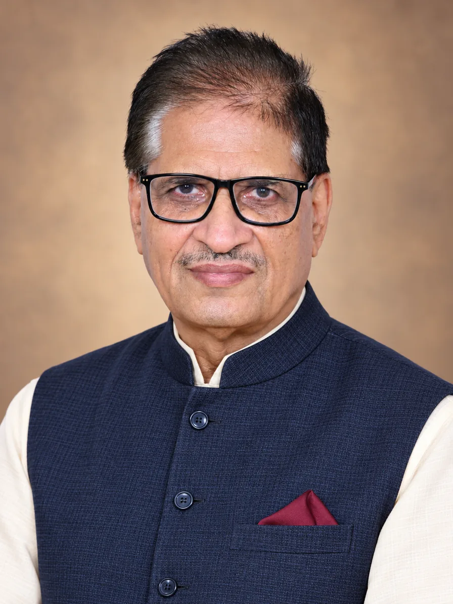 Dr. R.P. Sharma, Vedic astrologer — studio portrait in a navy Nehru jacket
